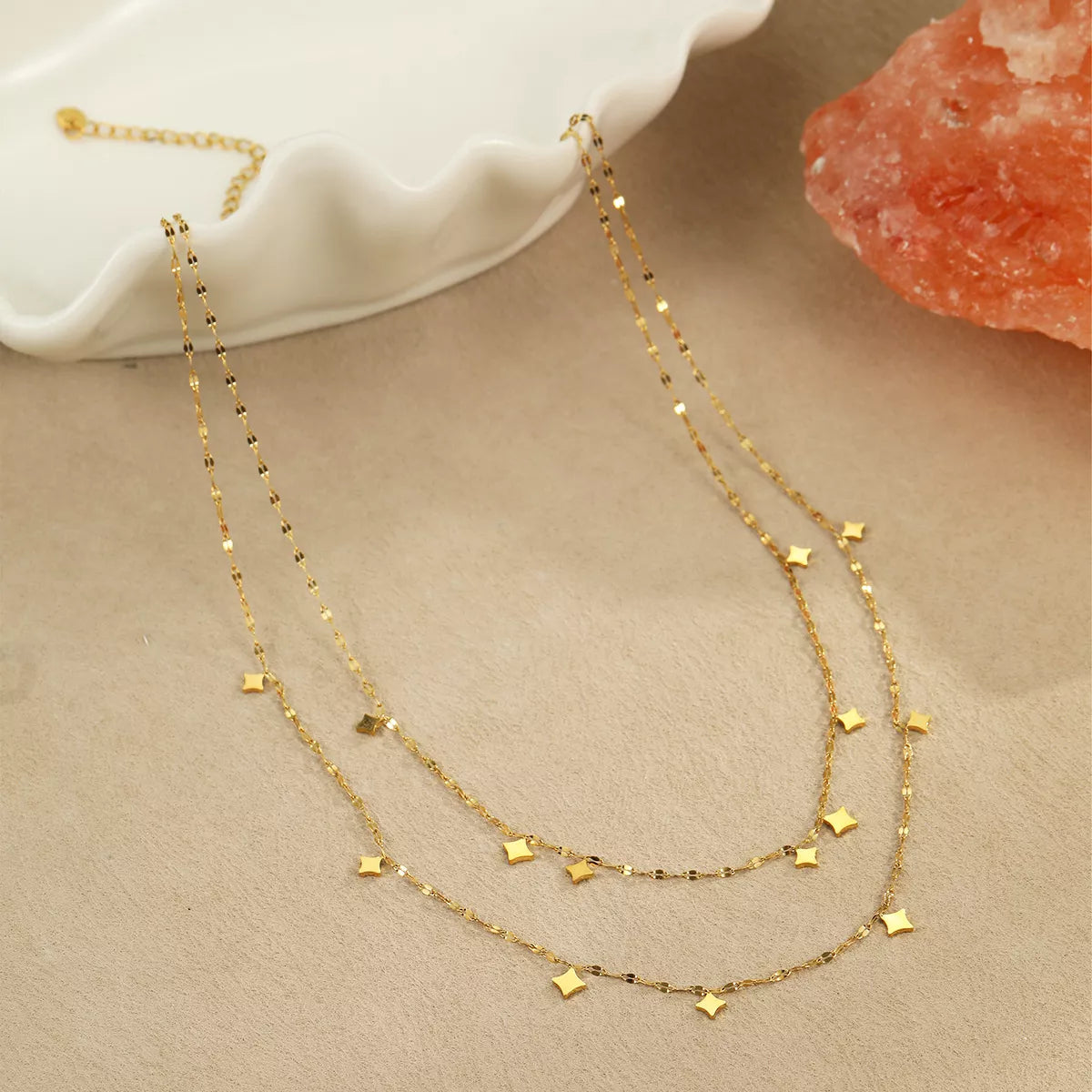 18K gold plated layered star charm necklace from Plush Fashion Hub featuring multiple star pendants on a delicate chain.