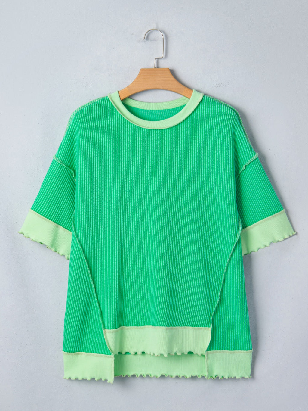 Women's ribbed twist hem short sleeve T-shirt with contrast stitching, showcasing the fitted design and stylish details.