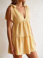 Gingham tie-shoulder mini dress by Plush Fashion Hub featuring a stylish skirt with a playful checkered pattern