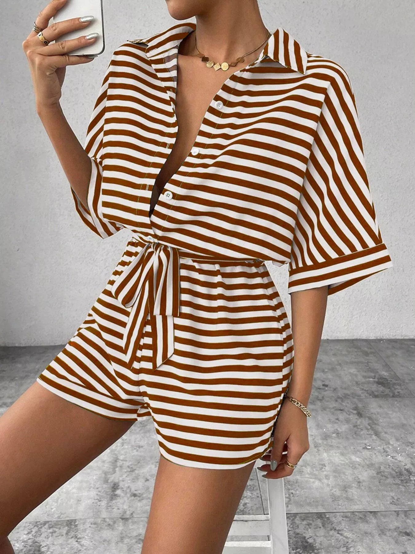 Striped button-front half sleeve romper shirt by Plush Fashion Hub, casual style with front buttons and a relaxed fit.