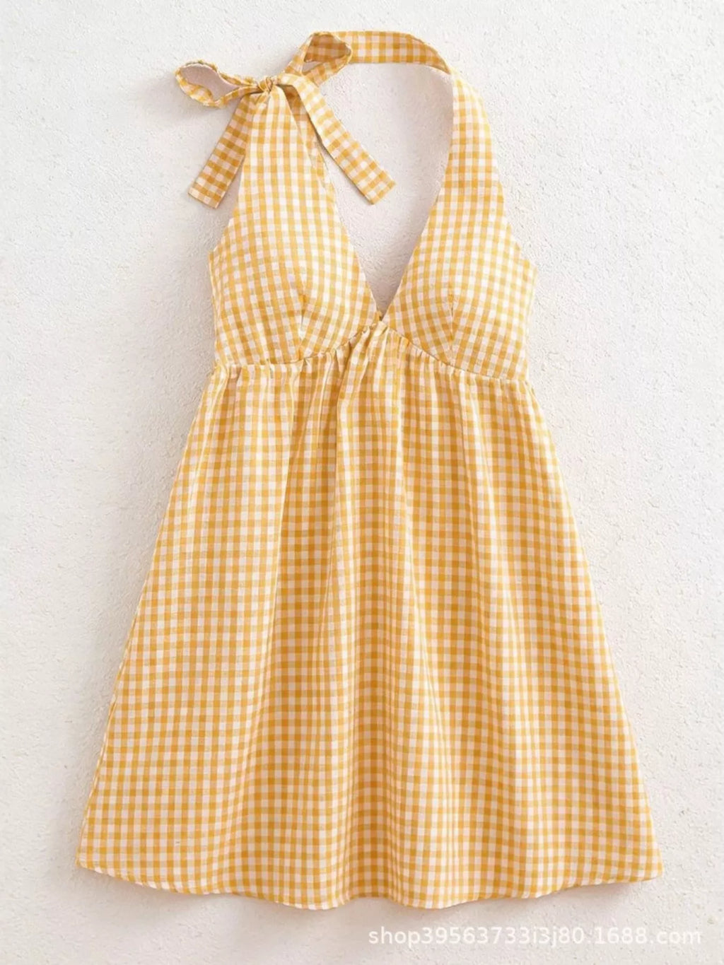 Gingham tie-shoulder mini dress by Plush Fashion Hub, featuring a stylish skirt with a classic checked pattern and shoulder ties.