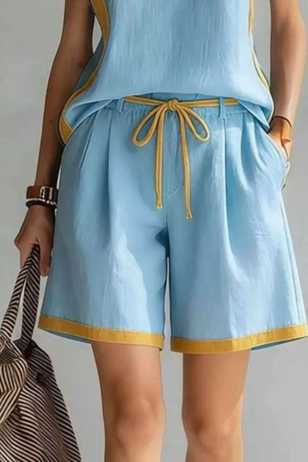 Contrast trim sleeveless tank and shorts loungewear set from Trendsi, featuring comfortable fabric and stylish design.