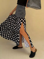 Flowy women's polka dot striped maxi skirt with slit, casual bohemian style, featuring lightweight fabric and relaxed fit.