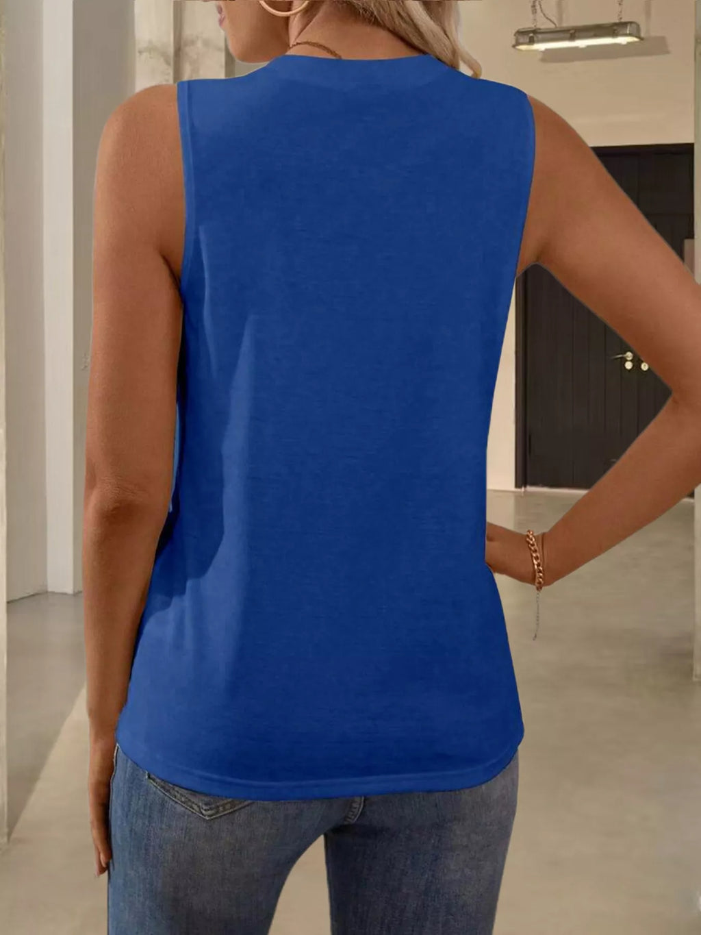 White round neck tank top from Trendsi, showcasing a sleeveless, casual tops design on a plain background.