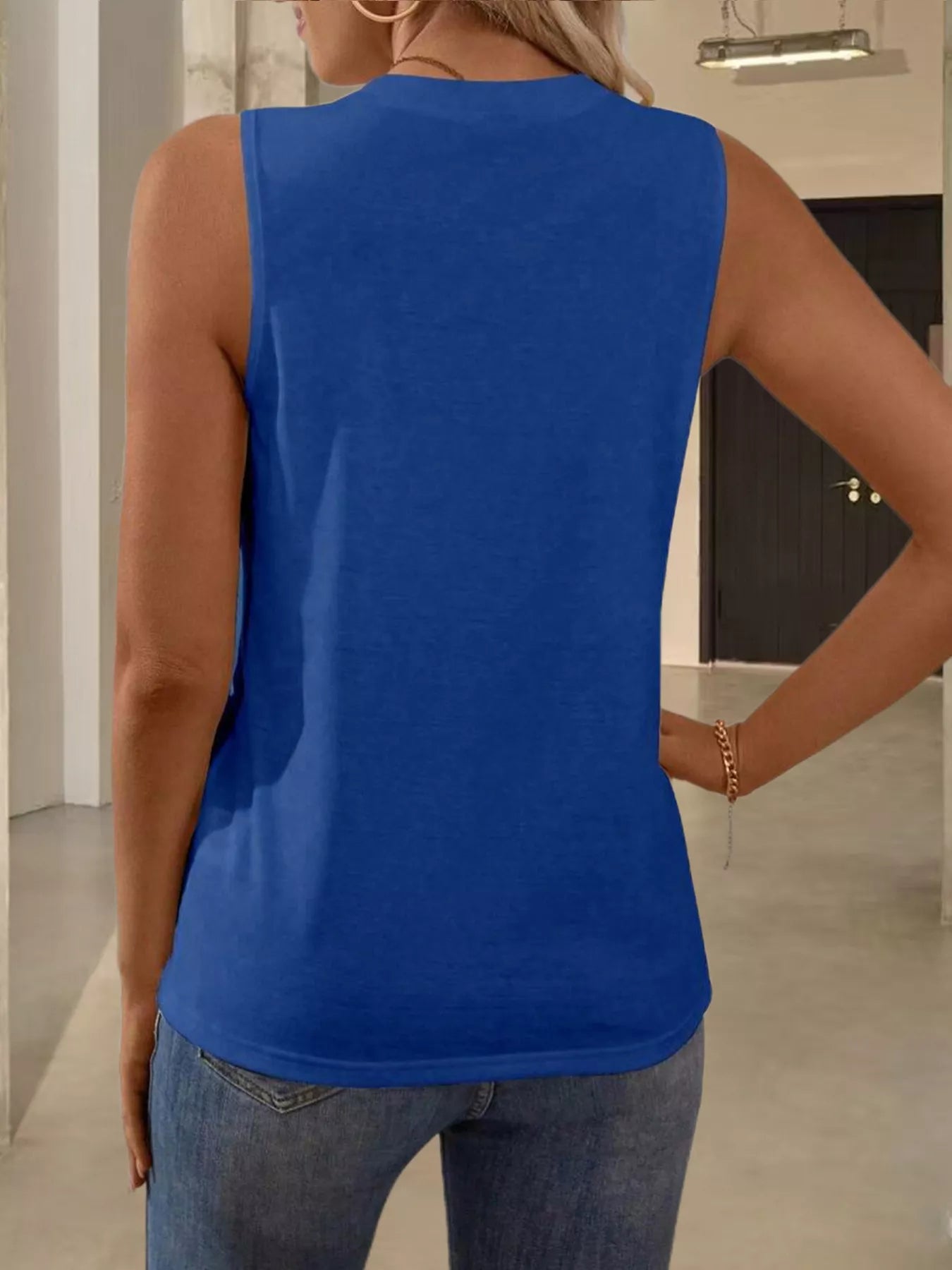 White round neck tank top from Trendsi, showcasing a sleeveless, casual tops design on a plain background.