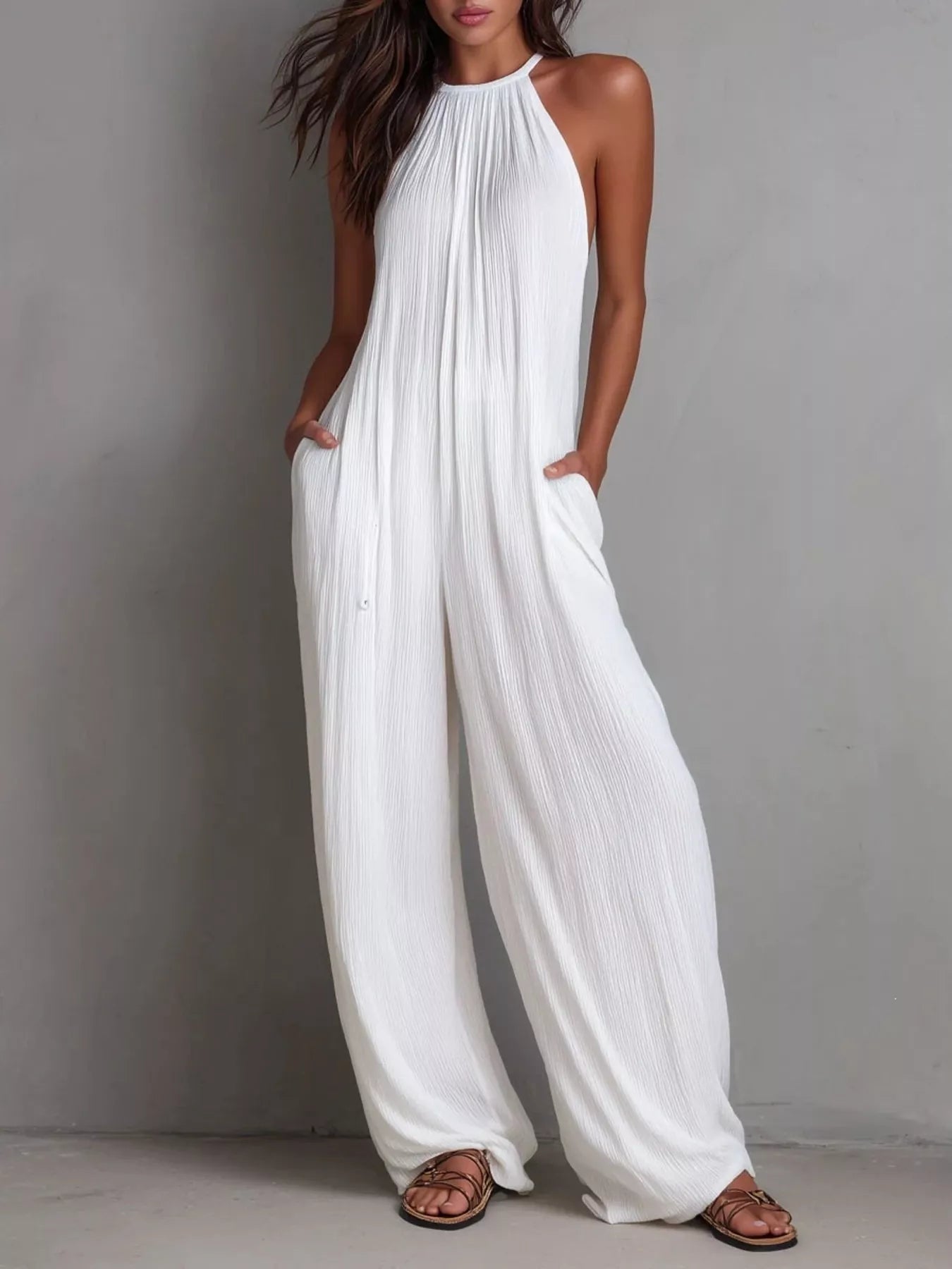 Plush Fashion Hub sleeveless wide-leg jumpsuit in lightweight fabric, shown on a model with a relaxed fit and modern style.