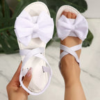 Shopimist bow embellished flat sandals with delicate straps and decorative bows for a stylish, comfortable summer look.