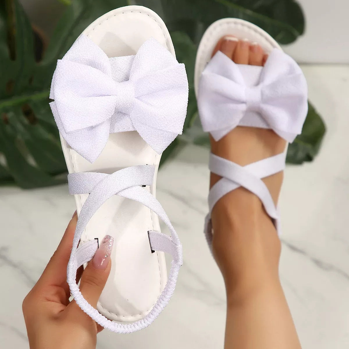 Shopimist bow embellished flat sandals with delicate straps and decorative bows for a stylish, comfortable summer look.