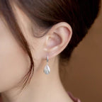 925 sterling silver drop earrings with a sleek, elegant design, featuring polished silver hooks and teardrop-shaped dangles.