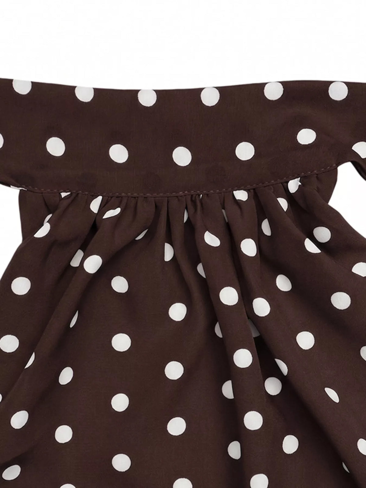 Plush Fashion Hub polka dot halter neck mini dress displayed on a hanger, showcasing its playful polka dot pattern and stylish silhouette.