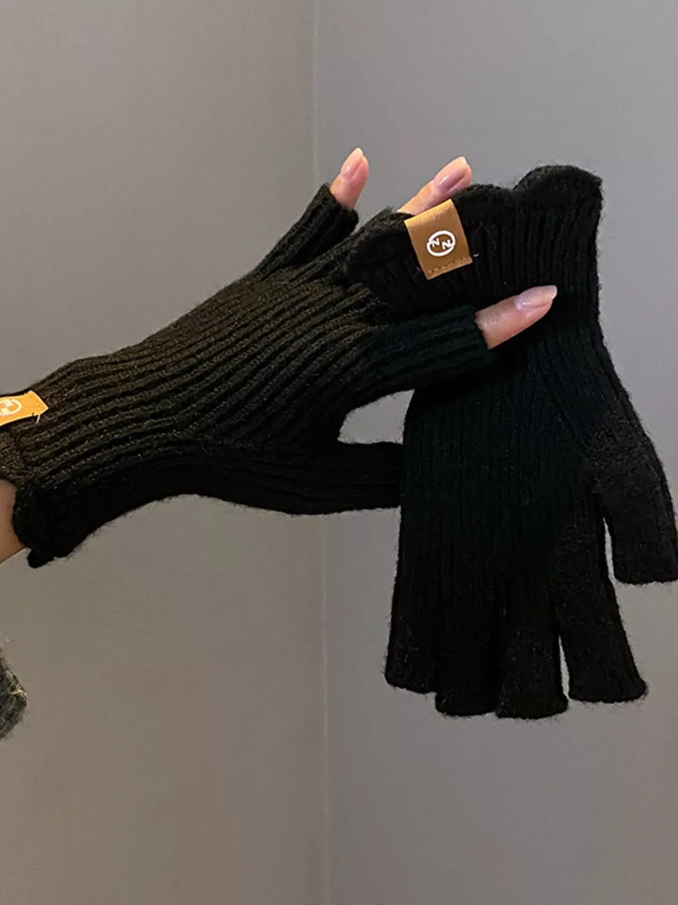 Pair of beige fingerless knitted gloves from Simply Love, showing their cozy, textured design and open fingertips.