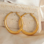 18K gold-plated hoop earrings with a sleek, shiny finish, designed for stylish wear and elegant accessory enhancement.