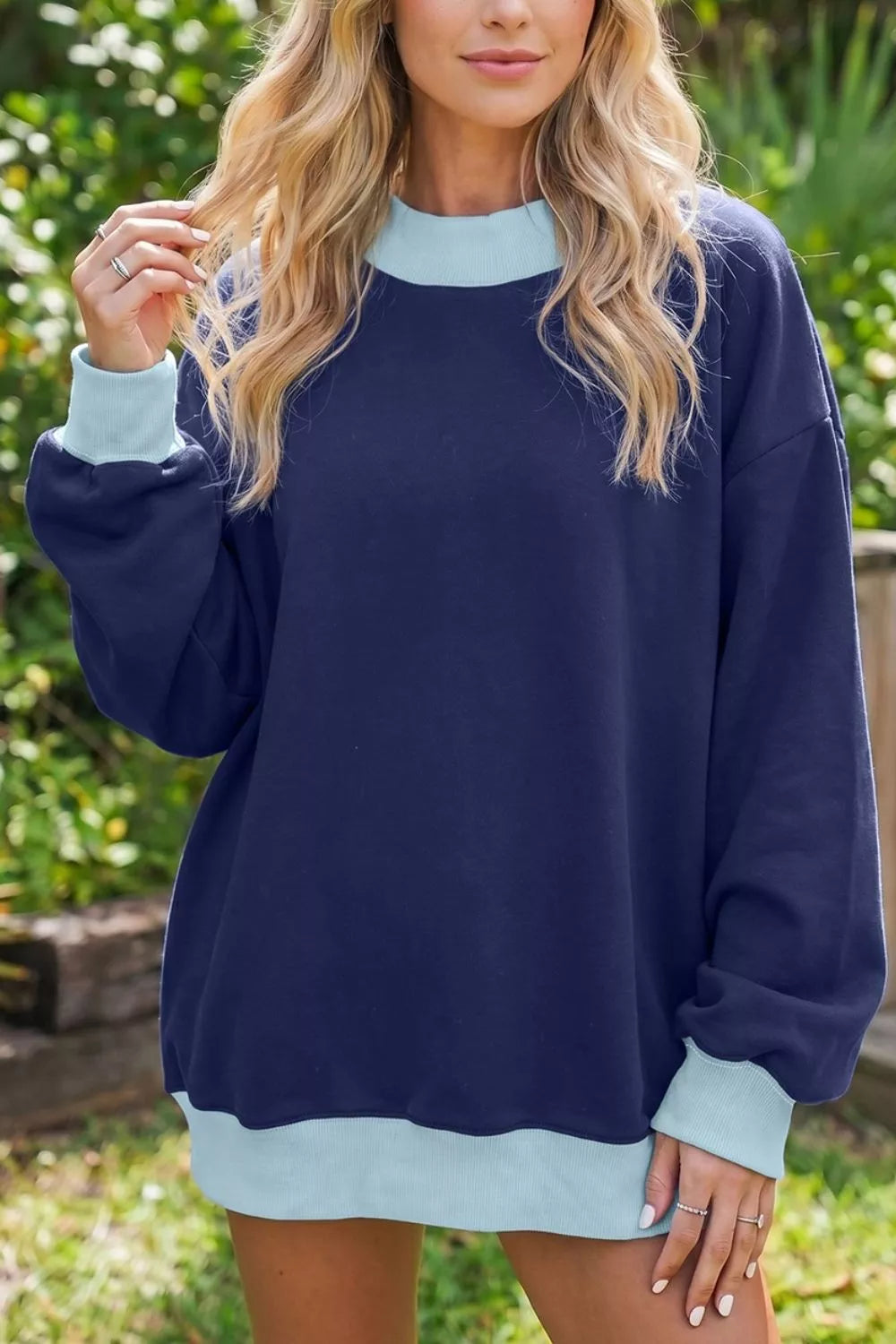 Colorblock trim crewneck long sleeve sweatshirt by Trendsi, featuring a stylish colorblock design and comfortable knit fabric.