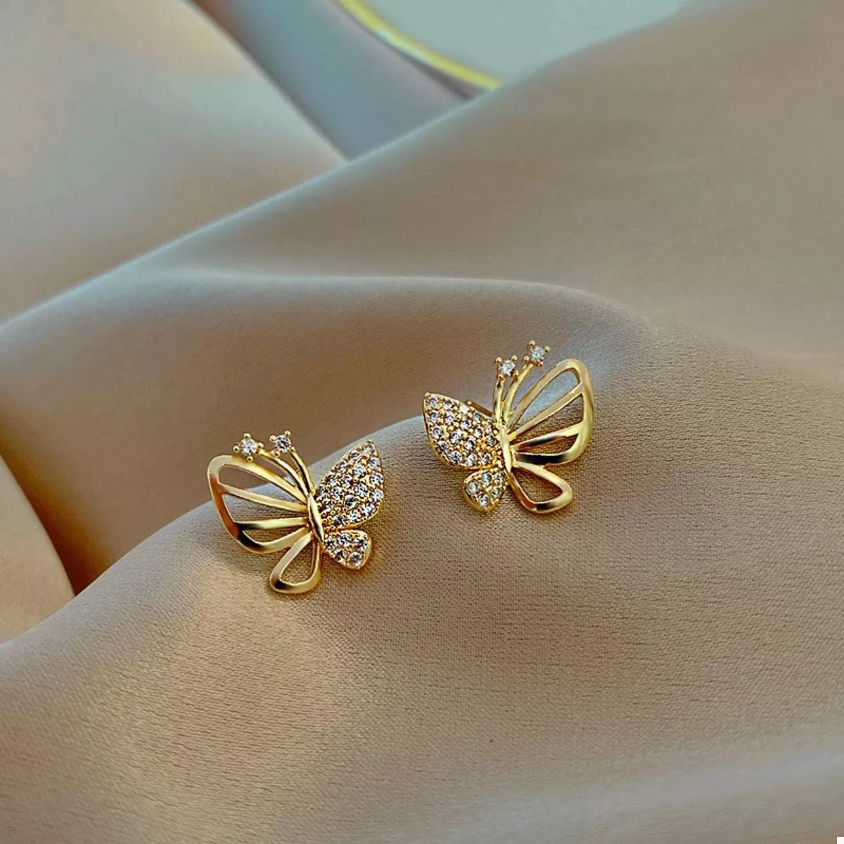 18K gold-plated butterfly stud earrings with delicate design, showcasing a shiny finish and butterfly shape.