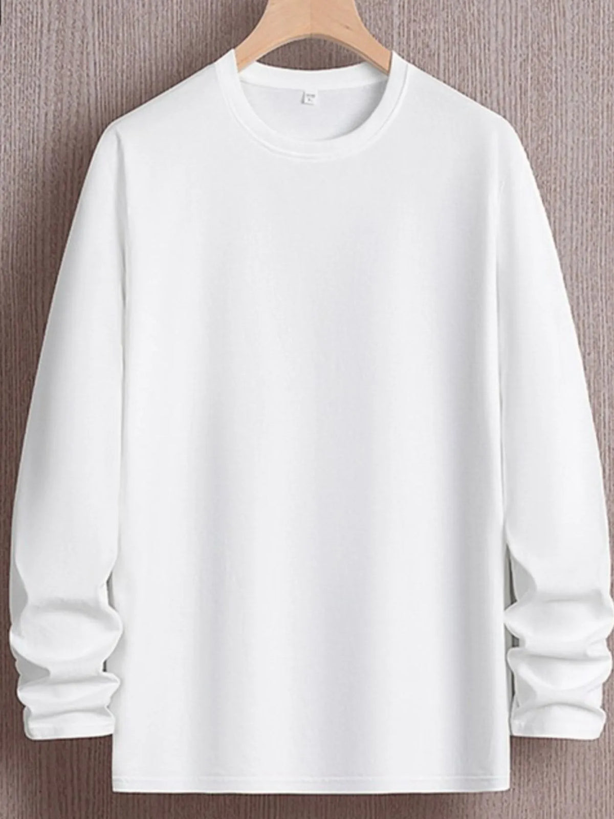 Men's plus size round neck long sleeve T-shirt by Trendsi, showing a comfortable fit and classic design in a neutral color.