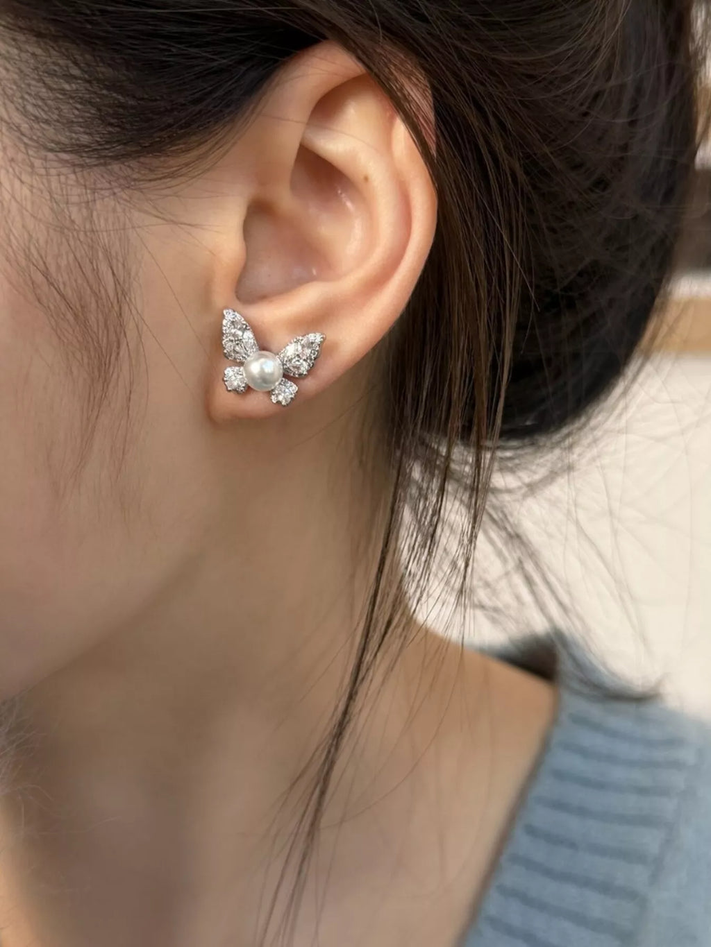 Butterfly pearl stud earrings by Shopimist featuring elegant white pearls and delicate butterfly design for a sophisticated look.