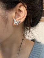 Butterfly pearl stud earrings by Shopimist featuring elegant white pearls and delicate butterfly design for a sophisticated look.