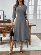 Classic plaid round neck midi dress with 3/4 sleeves from Trendsi, featuring a stylish and comfortable design.
