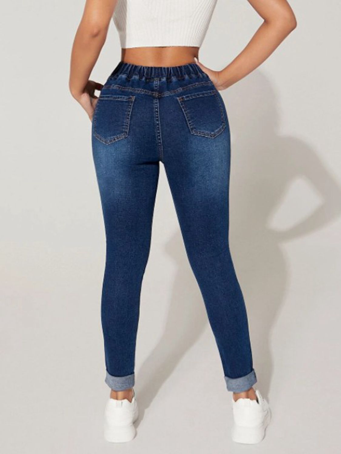 Plush Fashion Hub drawstring cropped denim jeans showing high-waist fit and stylish distressed details on a model.