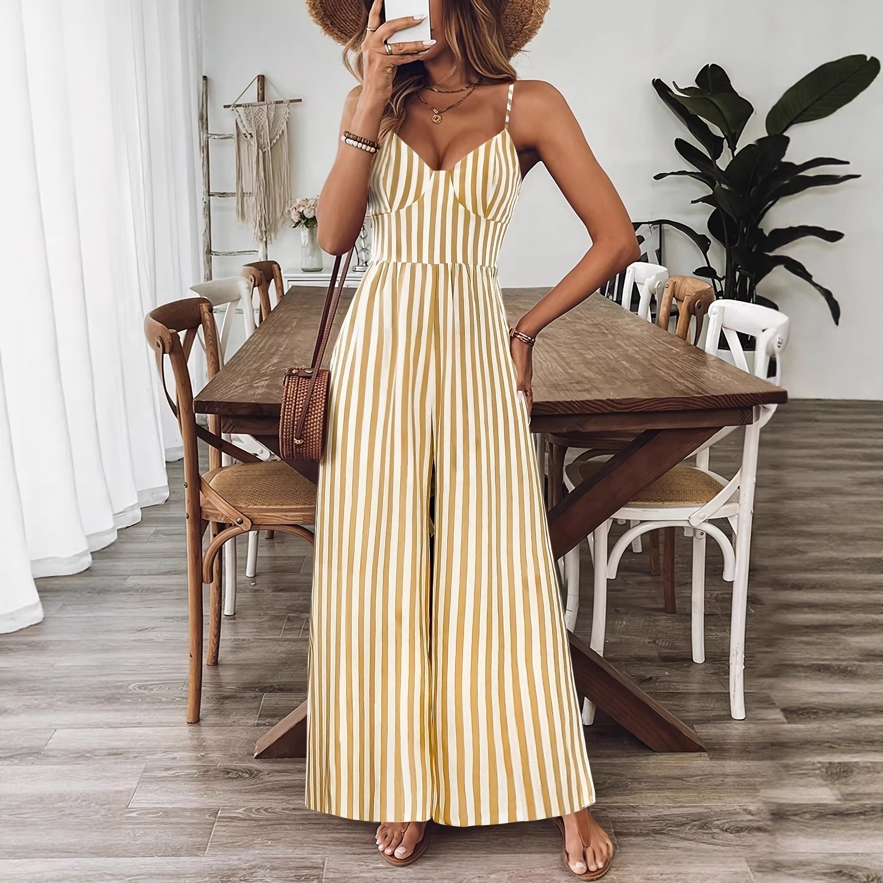 Yellow printed backless sleeveless strap jumpsuit by FitiqueFit, featuring a stylish backless design and slim straps.