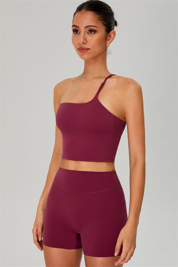 Fitglutes activewear set featuring a one-shoulder crop top and matching shorts for workout and gym activities.