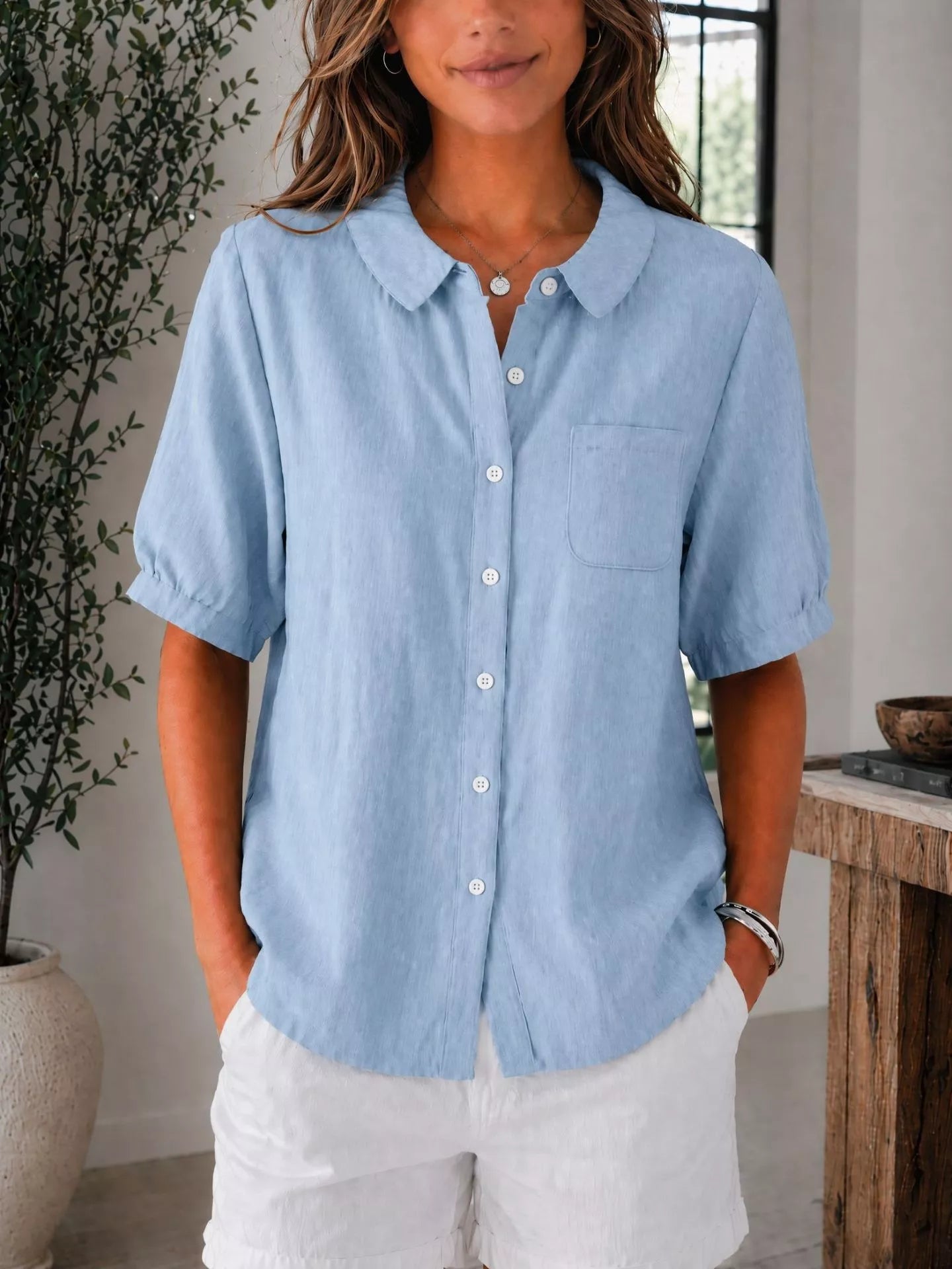 Plus size short sleeve button-up shirt by Trendsi, showing a full-length view of the stylish tops in a vibrant color.