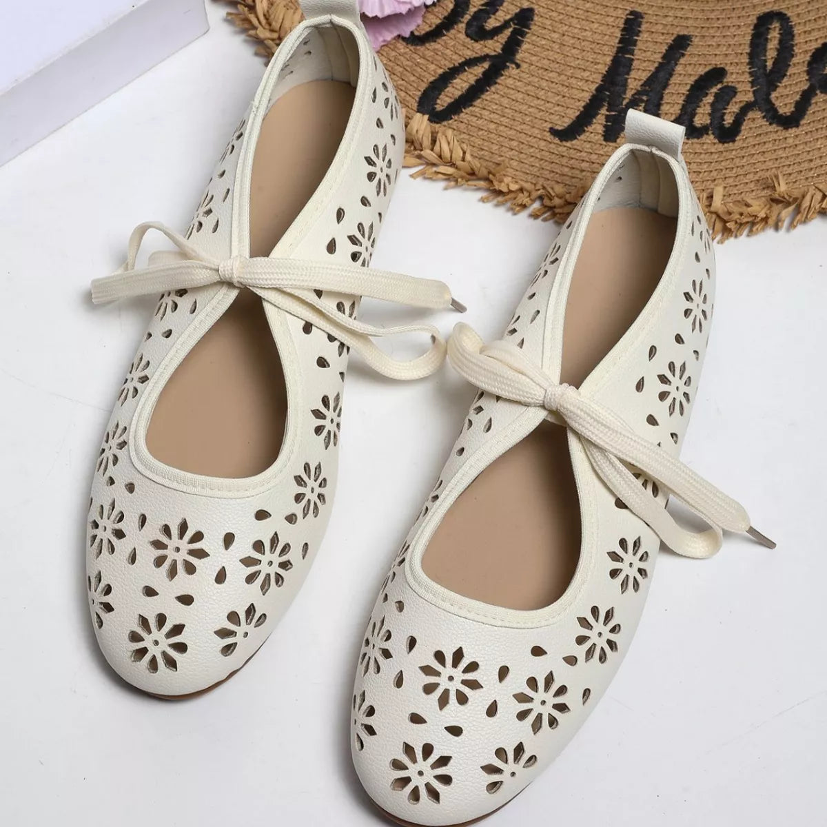 Plush Fashion Hub floral cutout tied slip-on sandals with open toes and decorative floral patterns, perfect for casual summer wear.