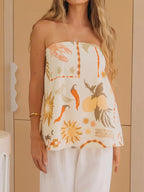 Printed slit-back tube top from Trendsi featuring a fitted design and stylish back slit, perfect for casual or party wear.