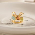 18K gold-plated gemstone open cuff ring with vibrant stones and sleek design, showcasing elegant jewelry craftsmanship.