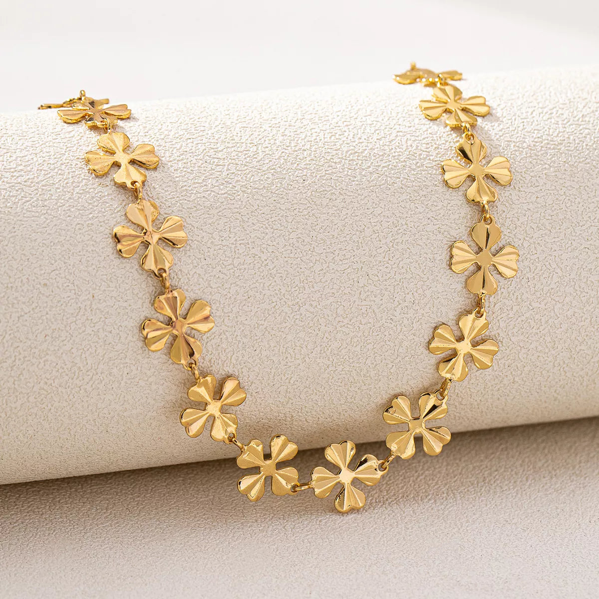 18K gold-plated alloy flower chain necklace with delicate floral design, shiny gold finish, and lightweight style.