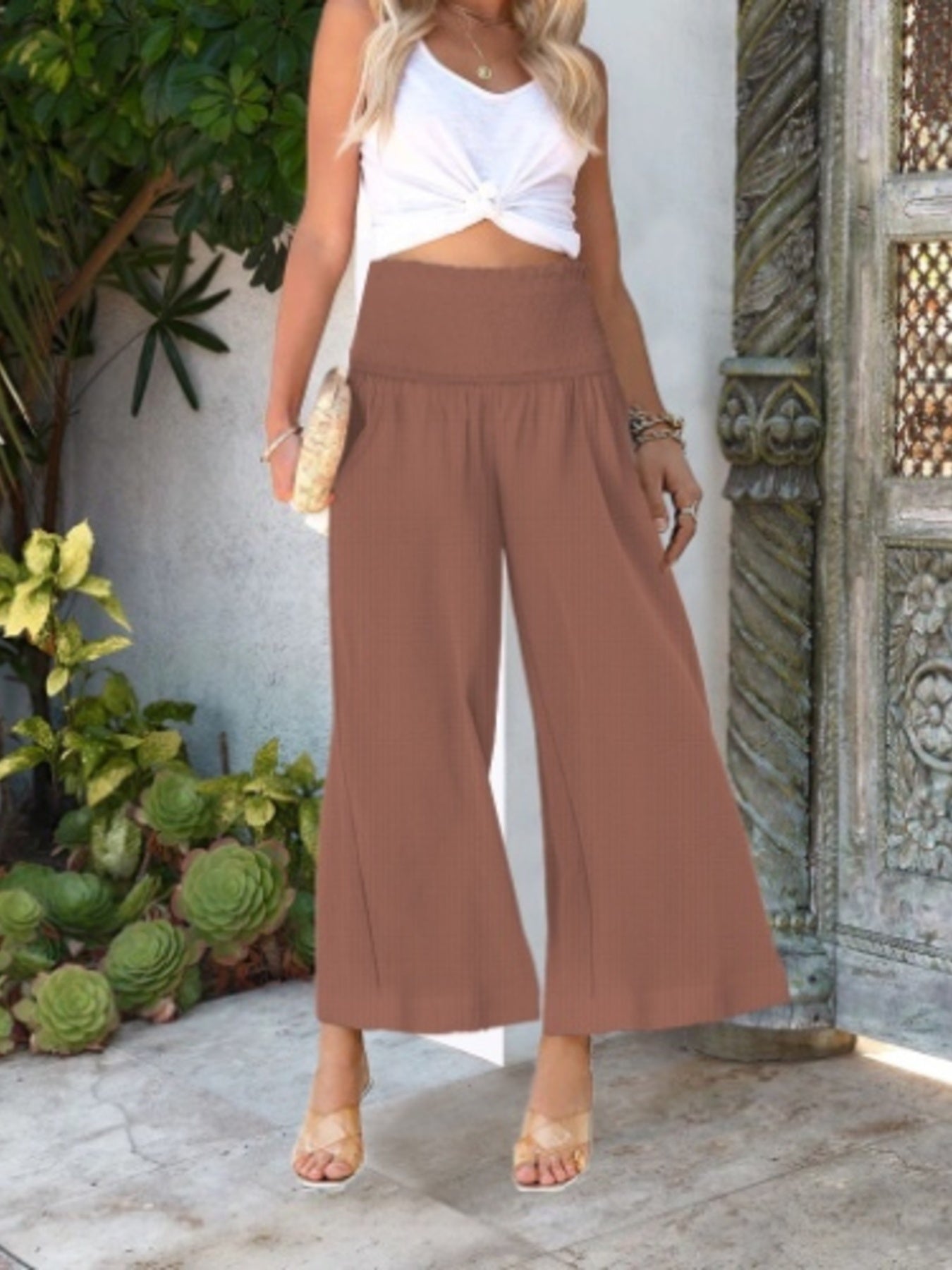 Women's wide-leg smocked waist casual trousers by Trendsi, lightweight and comfortable pants, shown in a relaxed fit and flowy fabric.