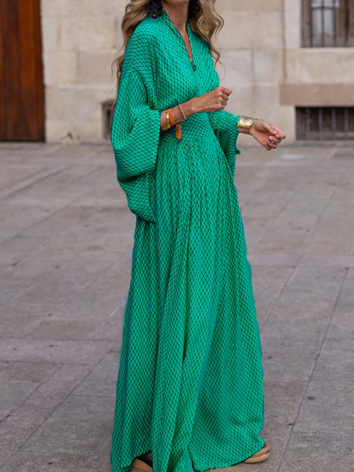 Elegant V-neck maxi dress with flowing sleeves, stylish and comfortable, perfect for summer or formal occasions.