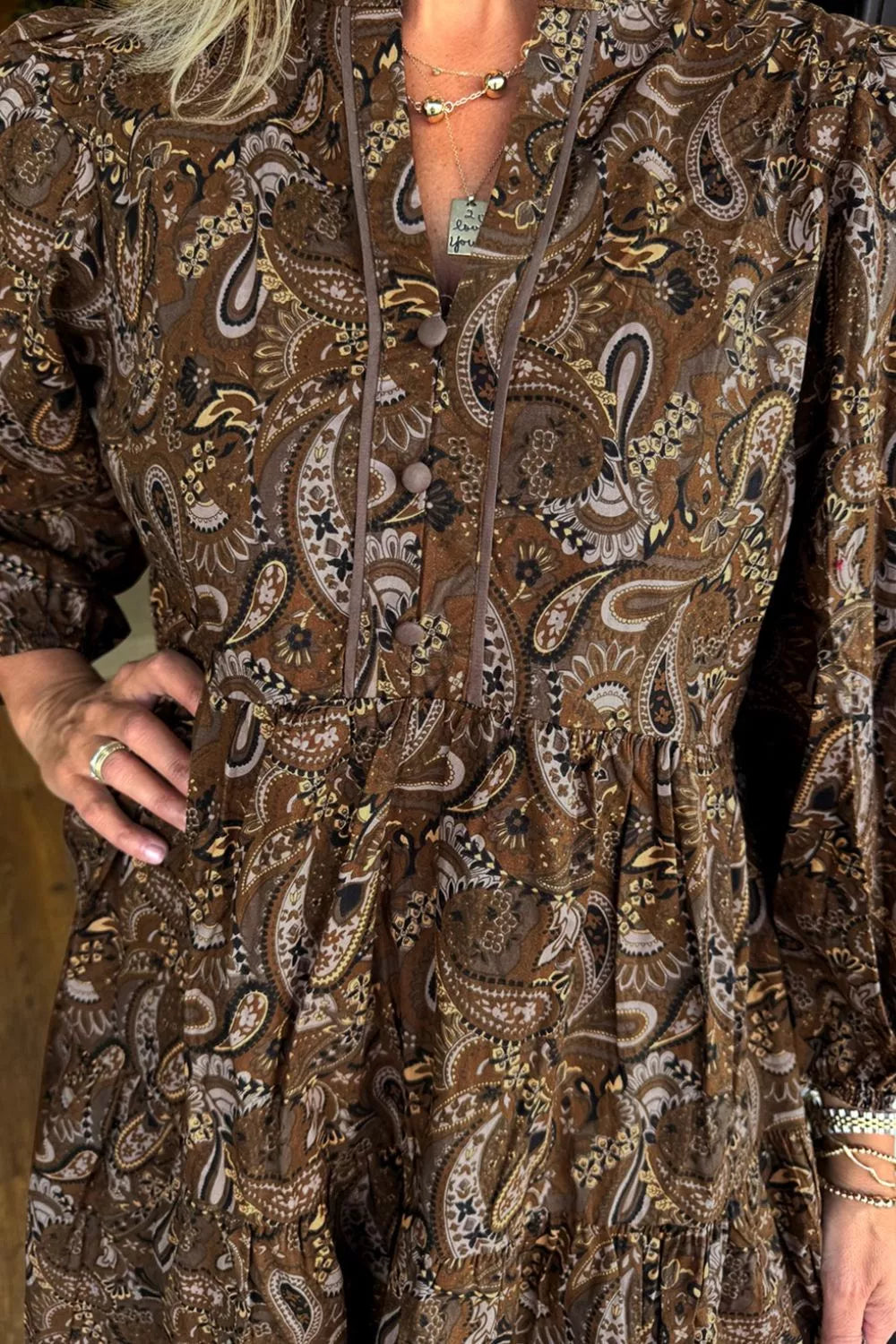 Paisley print notched mini dress by Plush Fashion Hub displayed on a hanger, showcasing the stylish design and vibrant pattern.