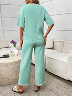 Women's casual two-piece lounge set with round neck top and drawstring pants by Trendsi, shown in comfortable, relaxed fit.
