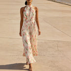 Women's halterneck high-waist swing dress by FitiqueFit featuring floral and solid print casualwear, flowing fabric and sleeveless design.