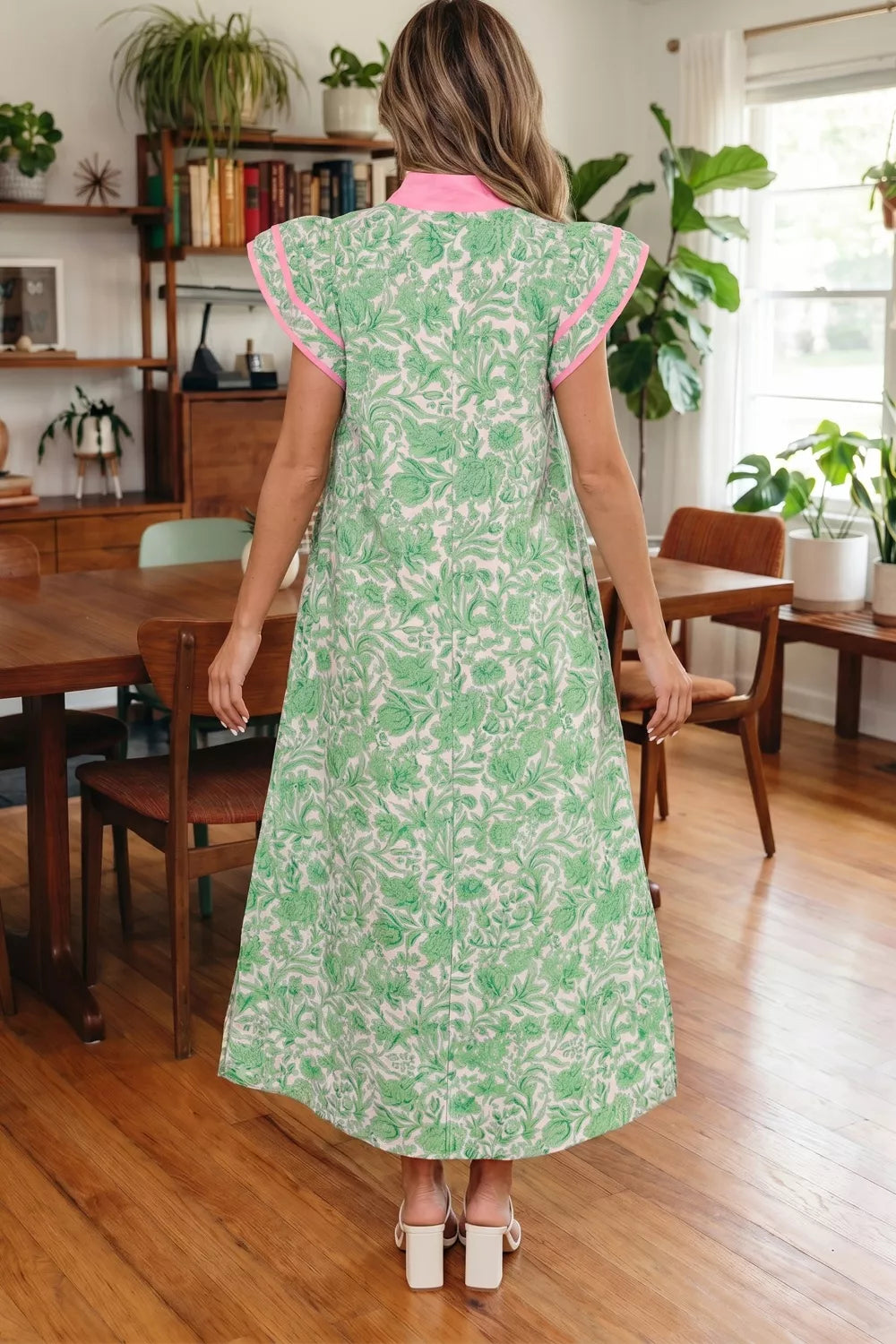 Floral midi dress with contrast trim and flutter sleeves by Plush Fashion Hub, showcasing a colorful floral pattern and feminine silhouette.