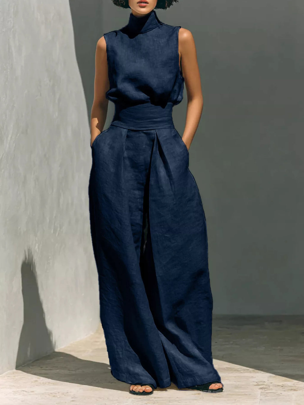 Sleeveless turtleneck top and wide-leg pants set by Trendsi, featuring a stylish, coordinated outfit in a sleek, modern design.