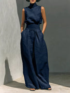 Sleeveless turtleneck top and wide-leg pants set by Trendsi, featuring a stylish, coordinated outfit in a sleek, modern design.