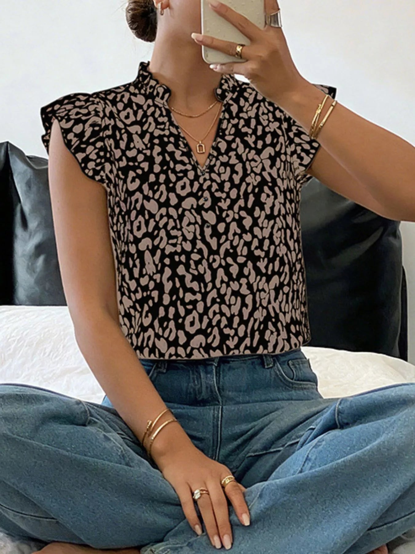 Leopard print ruffle sleeve blouse by Plush Fashion Hub, featuring a stylish pattern and feminine ruffle details on the sleeves.