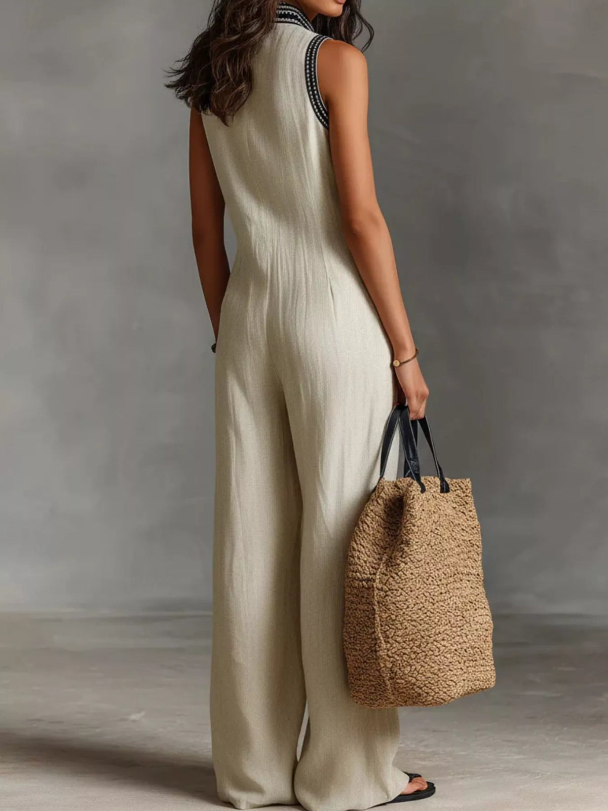 Plus size full length sleeveless wide-leg jumpsuit by Trendsi, featuring a flowing silhouette and stylish design.