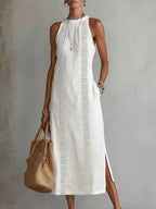 Sleeveless hollow-out midi dress with side slit and pockets by Plush Fashion Hub, showcasing the stylish design and fabric details.