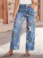 Floral print wide-leg jeans from Trendsi, featuring a relaxed fit and colorful floral pattern, displayed on a neutral background.