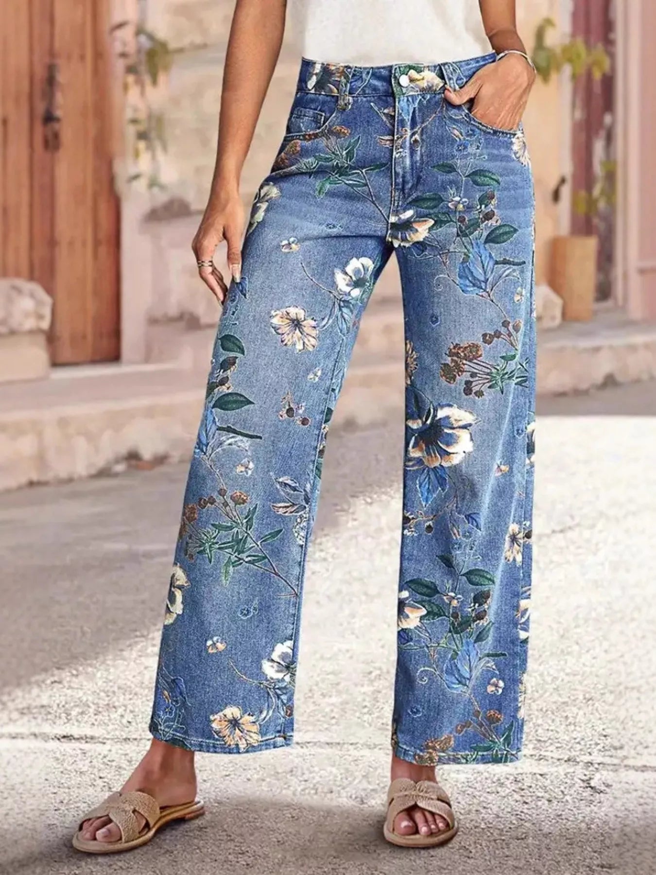 Floral print wide-leg jeans from Trendsi, featuring a relaxed fit and colorful floral pattern, displayed on a neutral background.