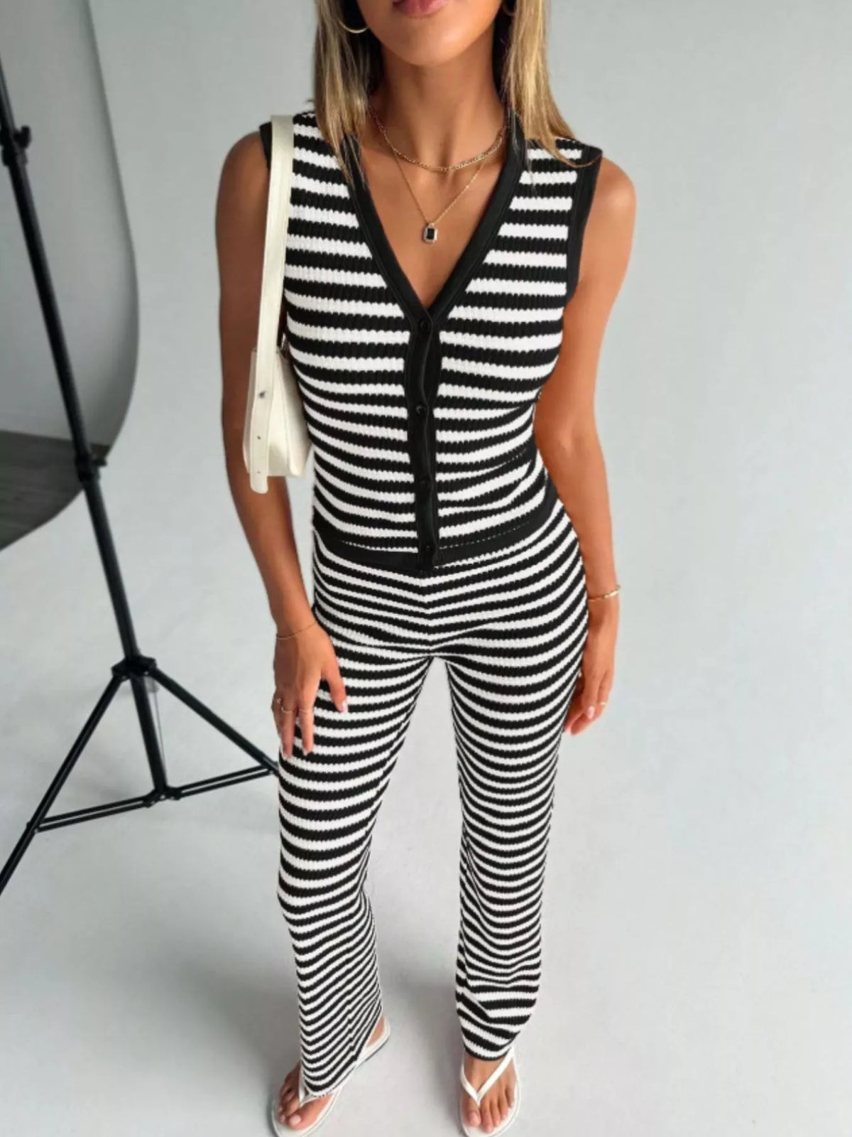 Striped knit V-neck sleeveless top and flare pants set by Plush Fashion Hub, featuring a stylish and comfortable matching outfit.