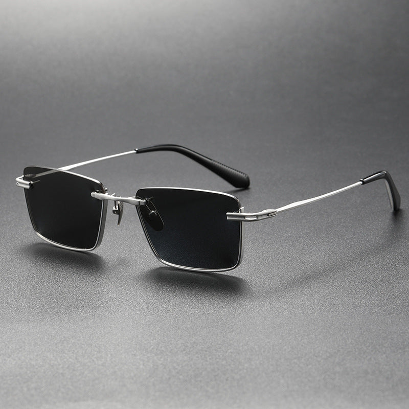 Pure titanium polarized sunglasses in retro British style, featuring sleek eye wear design with comfortable temples and reflective lenses.