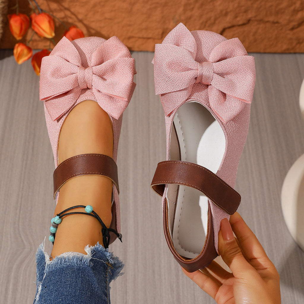 Women's chic bow round toe slip-on flats by Trendsi, made of comfortable vegan leather, featuring a stylish bow detail and easy slip-on design.