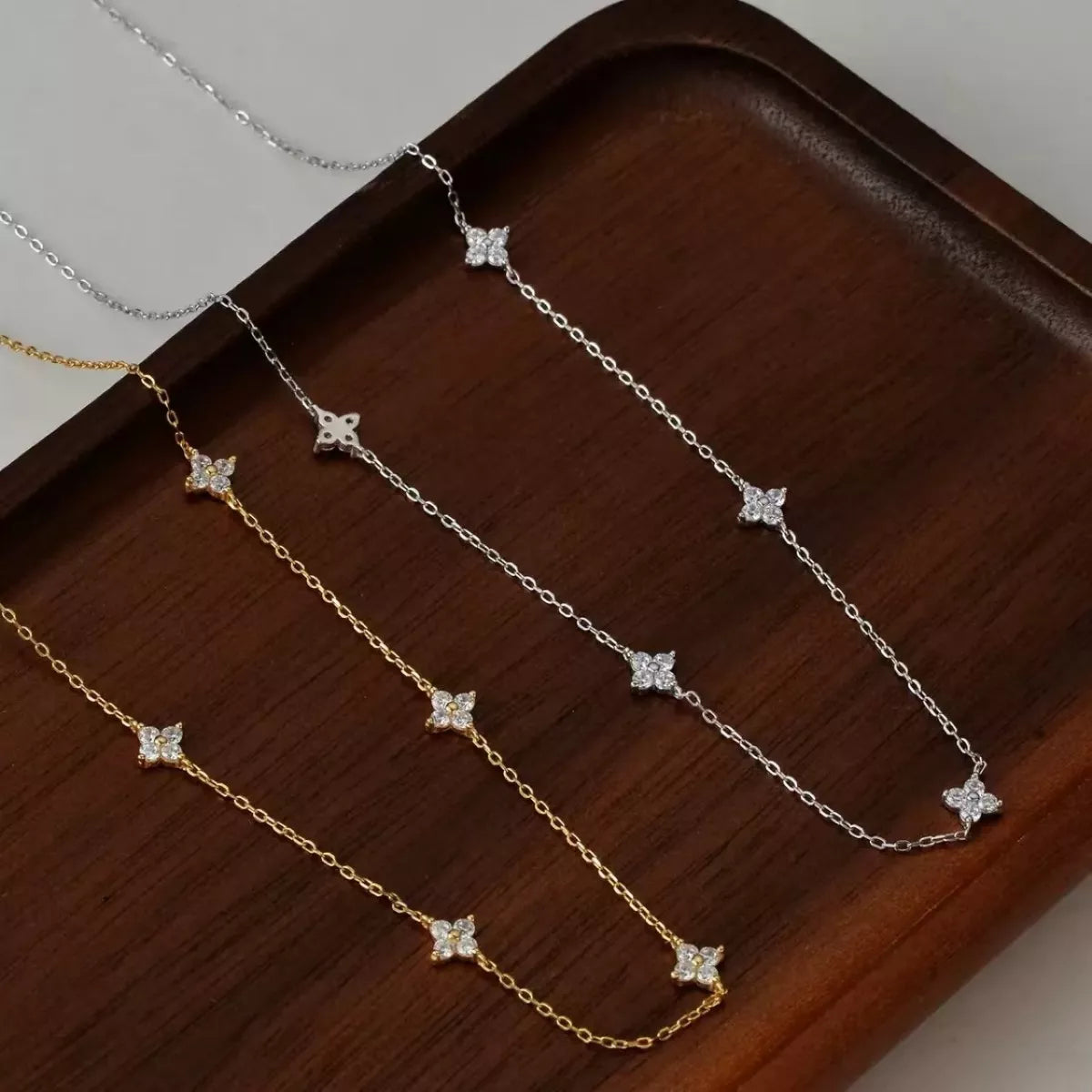 Sterling silver Clover Charm Necklace featuring a delicate four-leaf clover pendant on a fine chain.