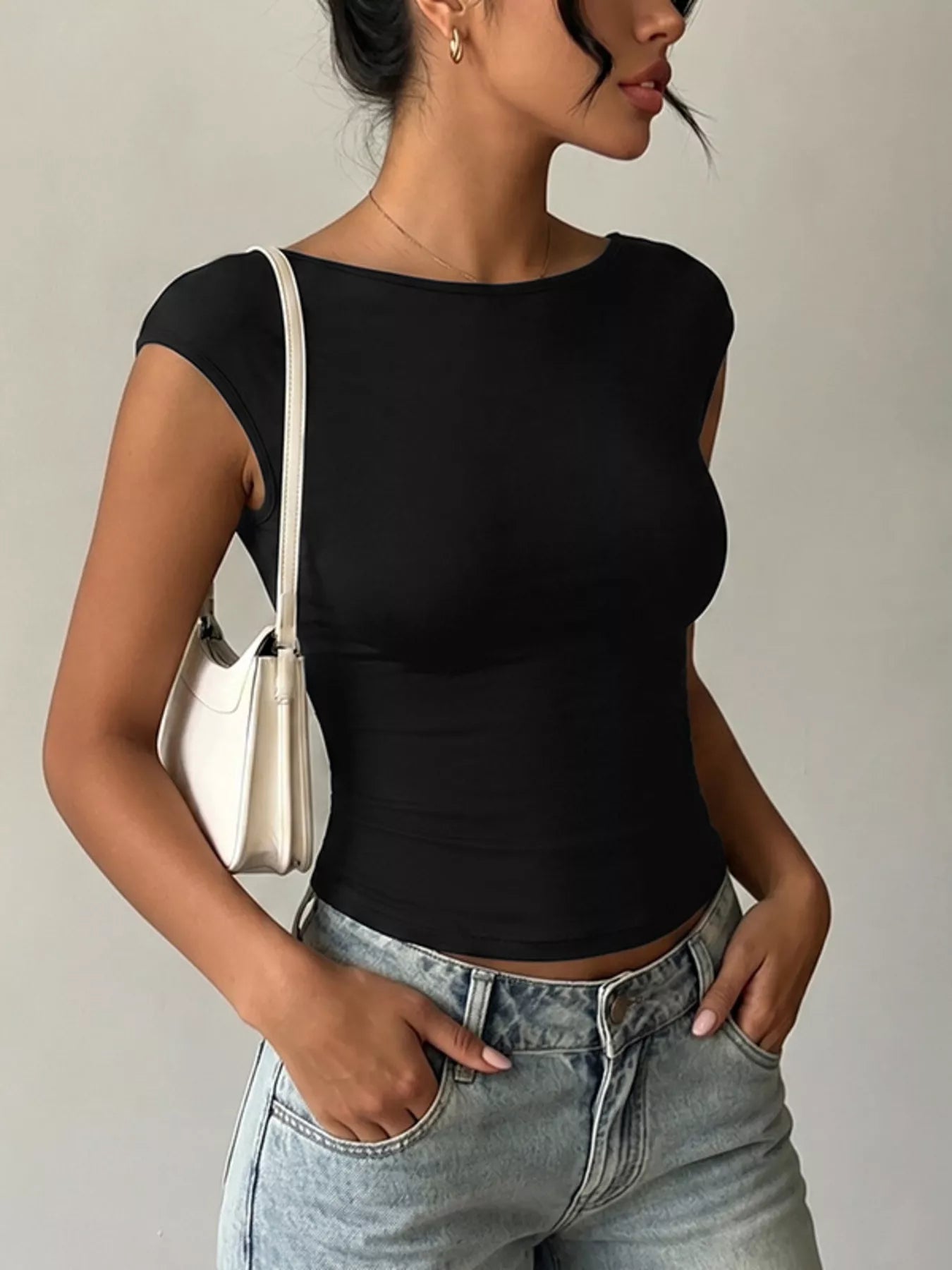 Lace detail cap-sleeve T-shirt from Trendsi, stylish tops with delicate lace accents and a comfortable fit, shown on a model.