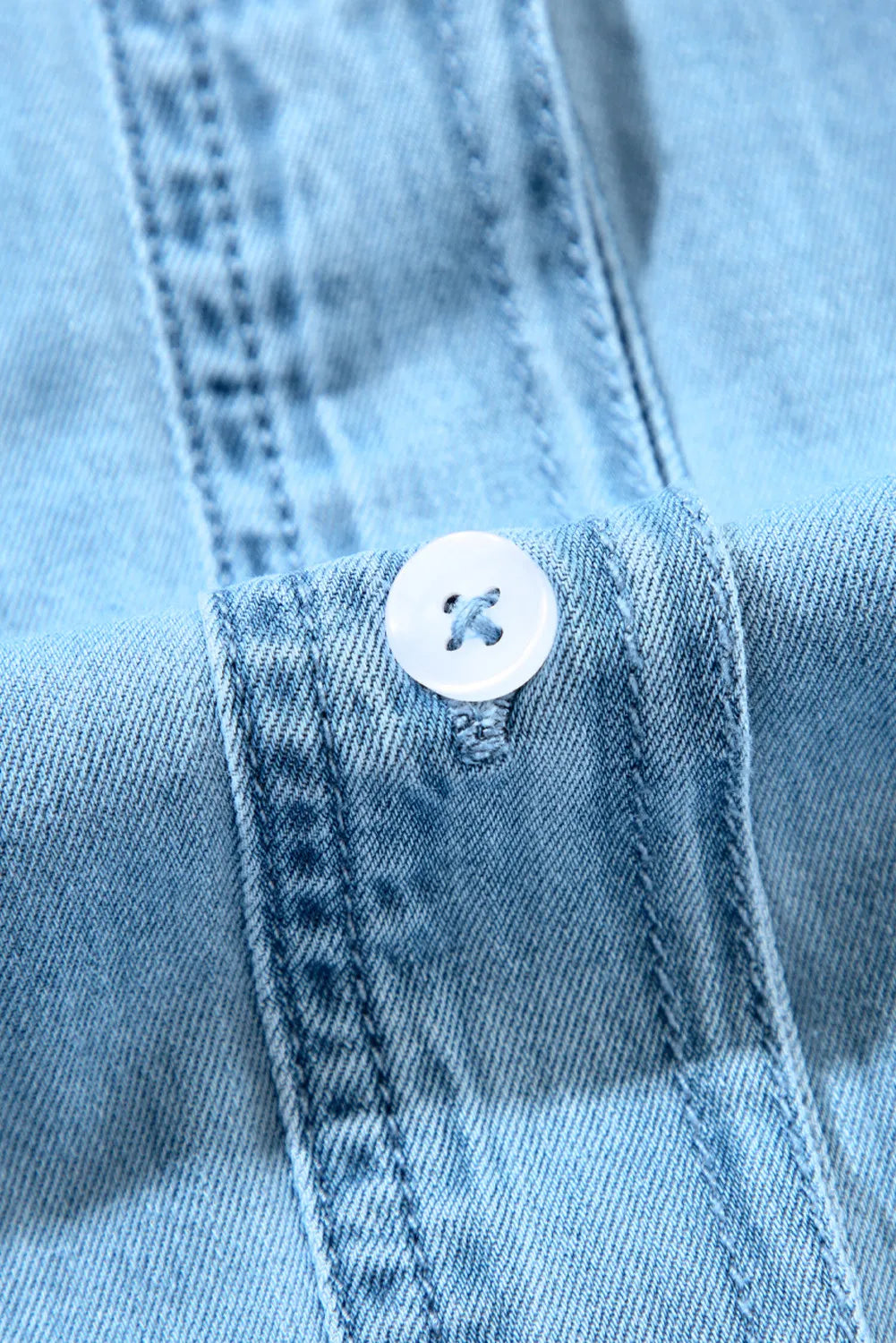 VYSN button-up denim dress with notched long sleeves, front buttons, and classic fit, displayed on a hanger.