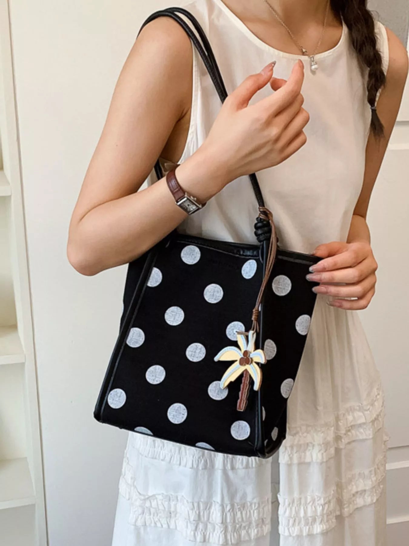 Polka dot shoulder handbag by Plush Fashion Hub, stylish hand bag with a polka dot pattern and shoulder strap.